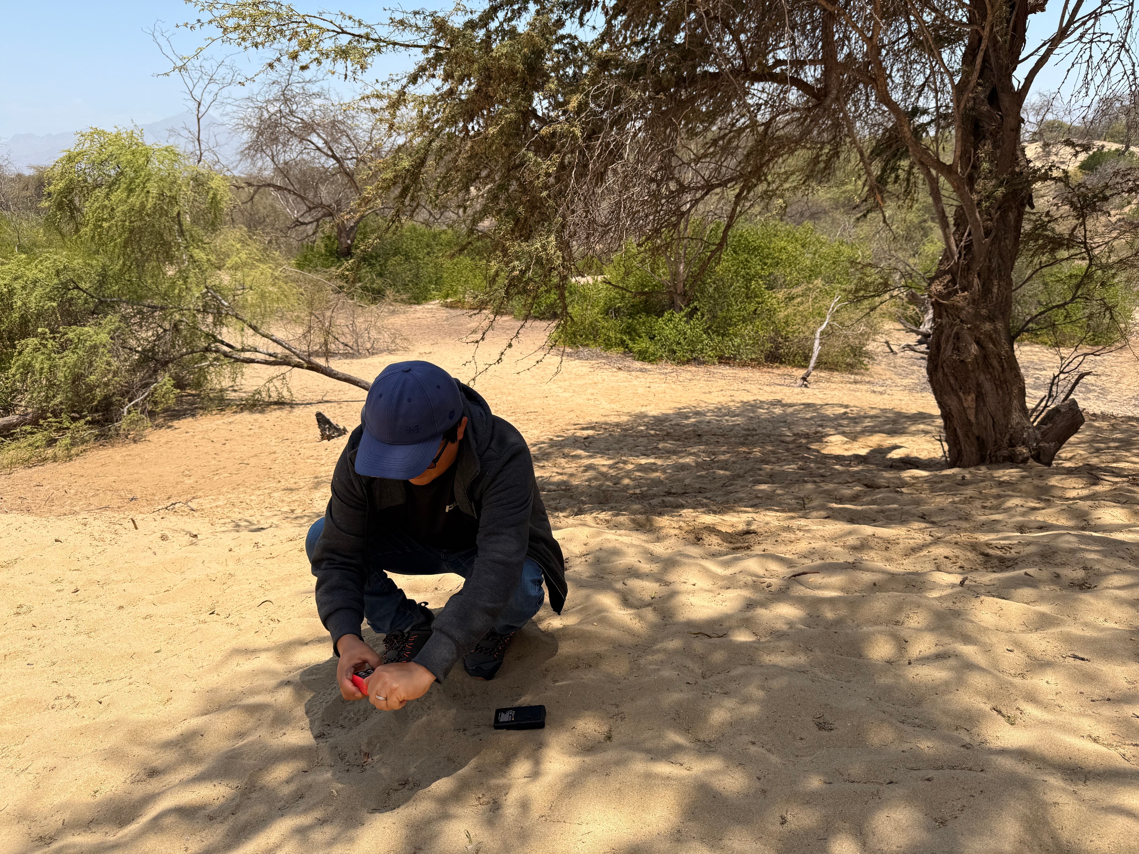 Investigador colectando muestras en arena